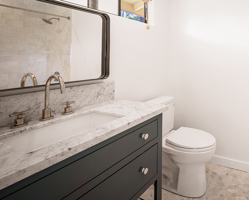 powder room with large vanity with marble top