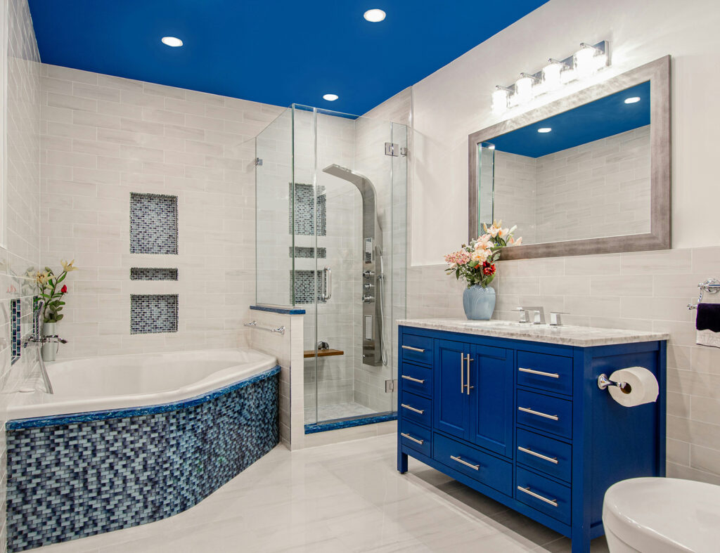 full bathroom with vibrant tile, vanity, and ceiling